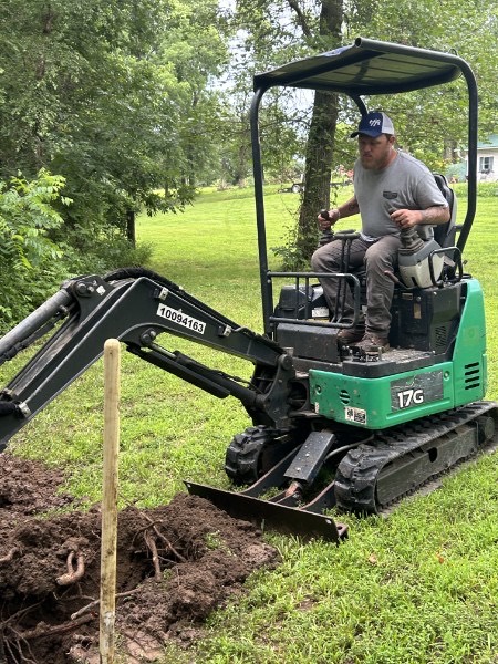 John Deere mini excavator digging a sewer trench in Vernon County, Missouri