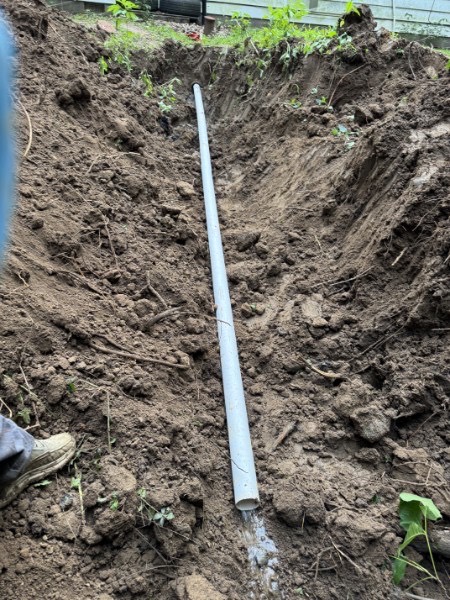 White PVC sewer pipe installed in an open trench in Richards, MO